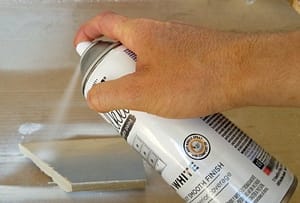 Photo of spray paint being applied to mirror frame.